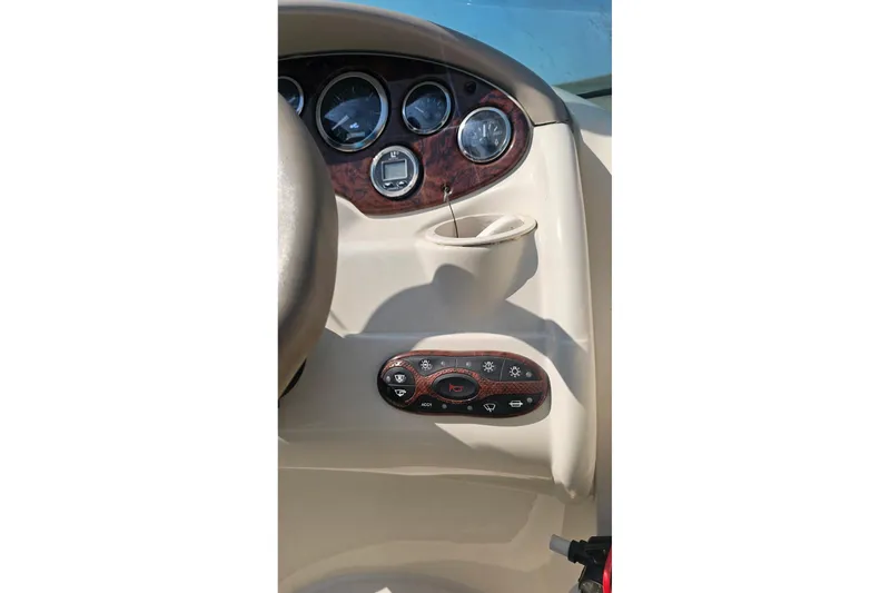 Slide: The Image of Dashboard of a 2003 Sea Ray 220 Sundeck boat with gauges and controls. - 20