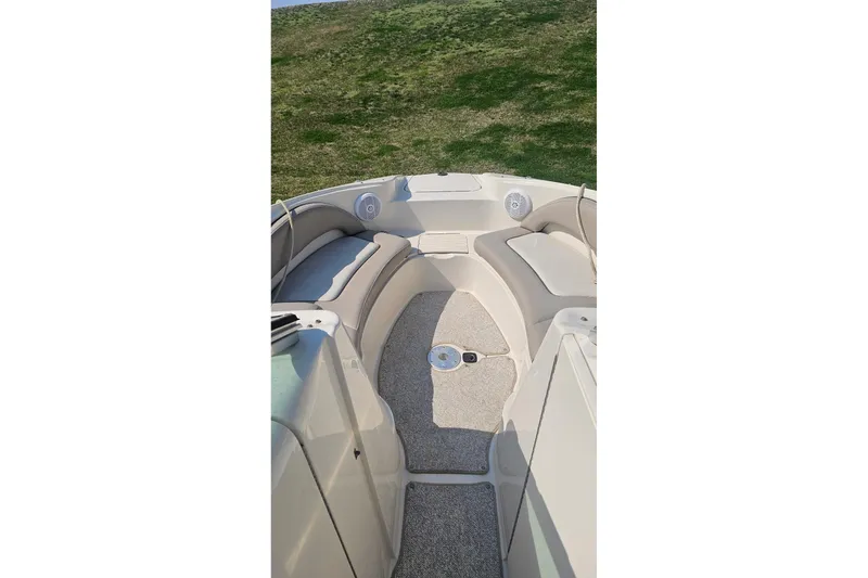 Slide: The Image of 2003 Sea Ray 220 Sundeck interior with beige seating and carpeted floor. - 21