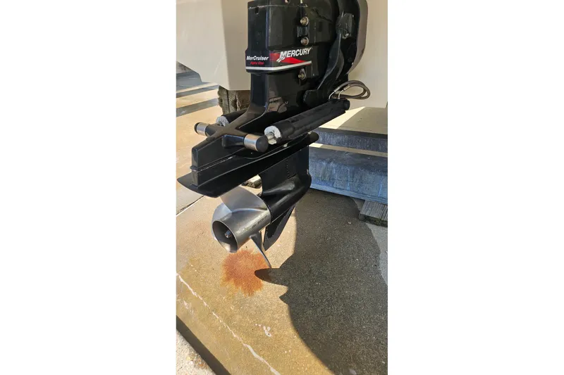 Slide: The Image of Close-up of a 2003 Sea Ray 220 Sundeck's MerCruiser outdrive on a concrete surface. - 22