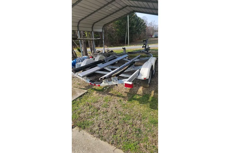 Slide: The Image of Boat trailer under a metal canopy, suitable for 2003 Sea Ray 220 Sundeck. - 24