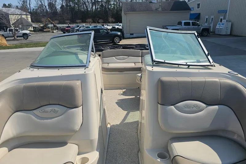 Slide: The Image of 2003 Sea Ray 220 Sundeck boat interior with beige seating and windshield. - 7