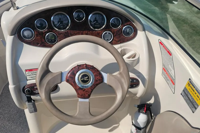 Slide: The Image of Steering wheel and dashboard of a 2003 Sea Ray 220 Sundeck boat. - 9