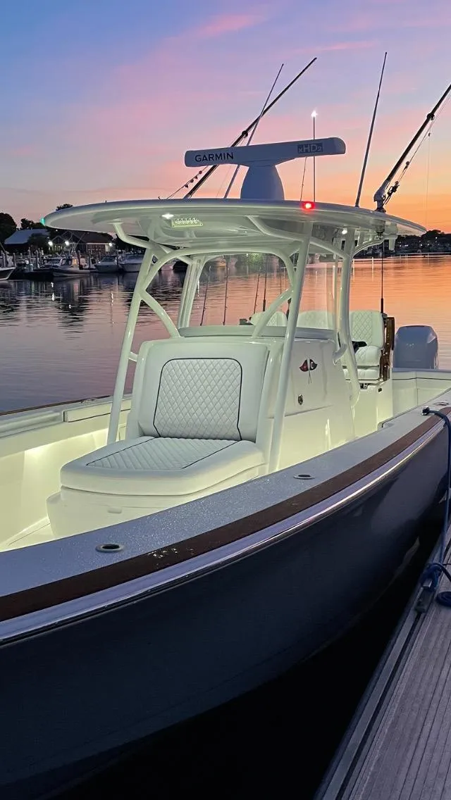 Slide: The Image of 2022 Valhalla V-33 Center Console boat at sunset, docked by the water. - 10