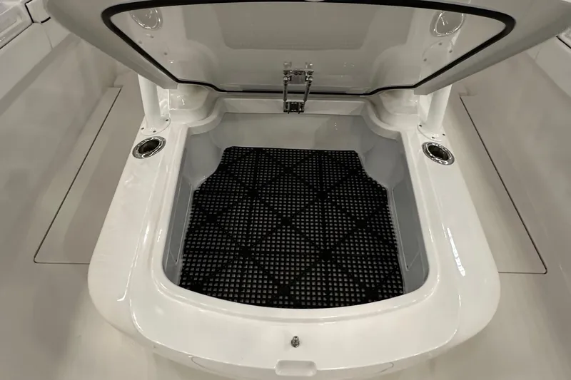 Slide: The Image of 2022 Valhalla V-33 Center Console storage compartment with open lid and black mat. - 20
