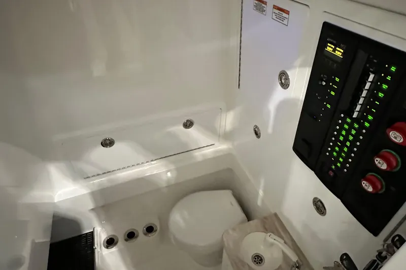Slide: The Image of 2022 Valhalla V-33 Center Console interior with control panel and toilet. - 21