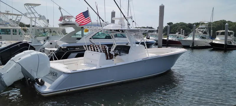 Slide: The Image of 2022 Valhalla V-33 Center Console boat docked in marina with American flag. - 25