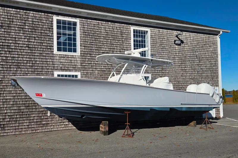 Slide: The Image of 2022 Valhalla Boatworks V-33, sleek design, parked on stands, for sale sign visible. - 26