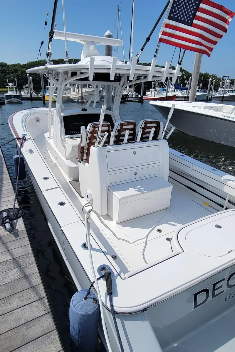 Slide: The Image of 2022 Valhalla V-33 Center Console boat docked, featuring sleek design and American flag. - 6