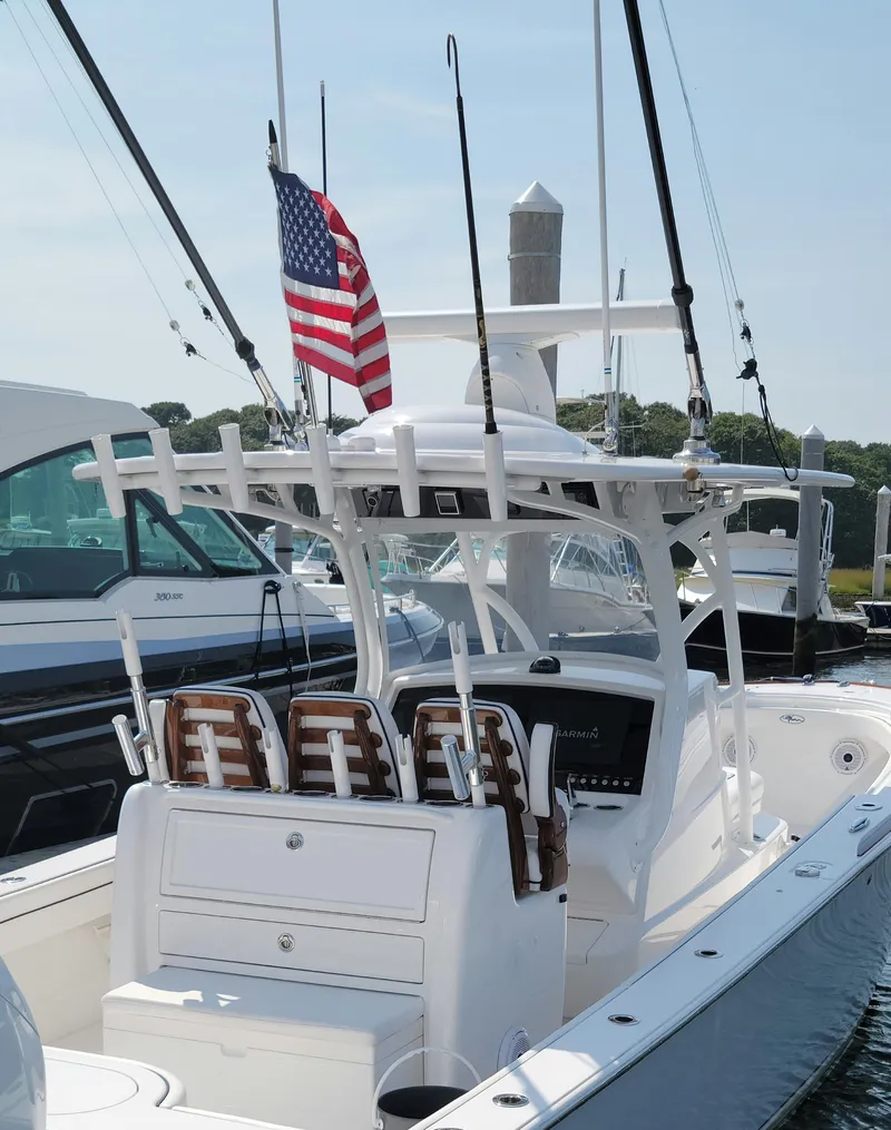 Slide: The Image of 2022 Valhalla V-33 Center Console boat with American flag, docked in marina. - 7