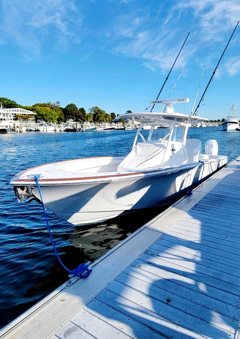 Slide: The Image of 2022 Valhalla V-33 Center Console boat docked by the water. - 9