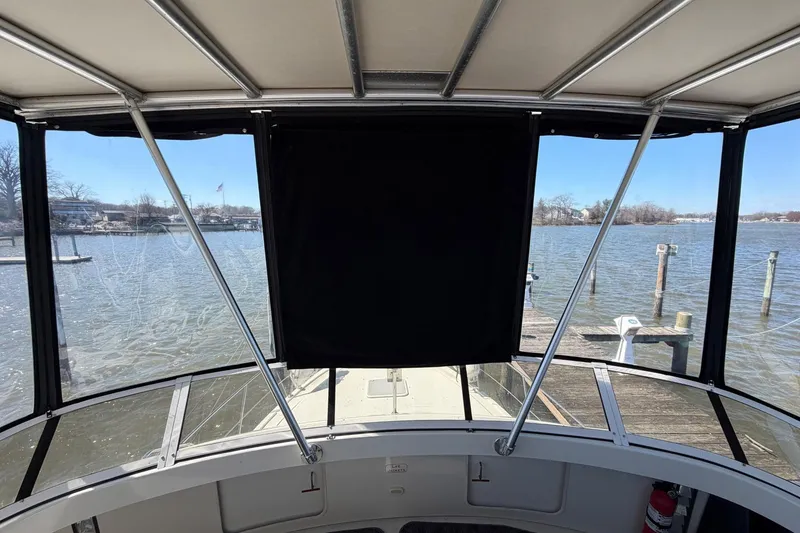 Slide: The Image of 1997 Carver 400 Cockpit Motor Yacht docked, view from cockpit with water and pier. - 17