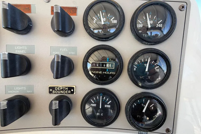 Slide: The Image of Control panel of a 1997 Carver 400 Cockpit Motor Yacht with gauges and switches. - 23