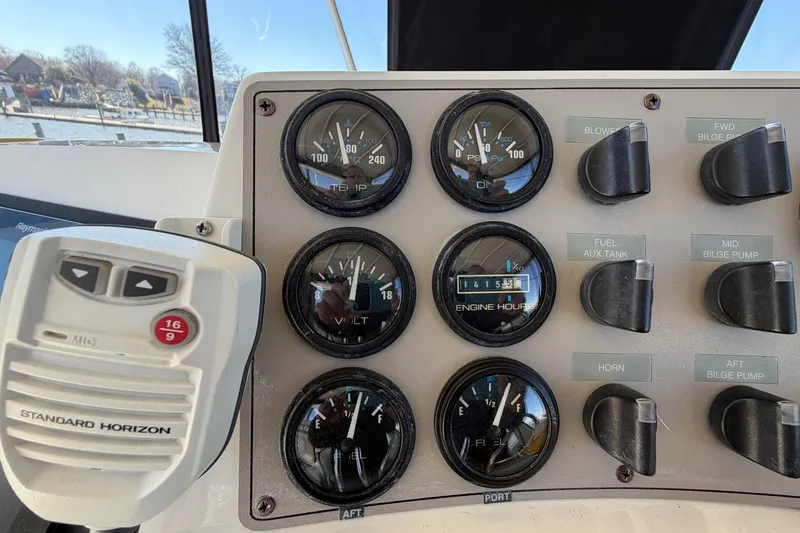 Slide: The Image of Control panel of a 1997 Carver 400 Cockpit Motor Yacht with gauges and switches. - 24