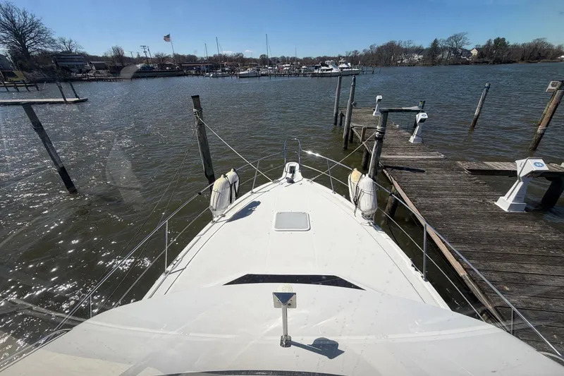 Slide: The Image of 1997 Carver 400 Cockpit Motor Yacht docked at a marina on a sunny day. - 27