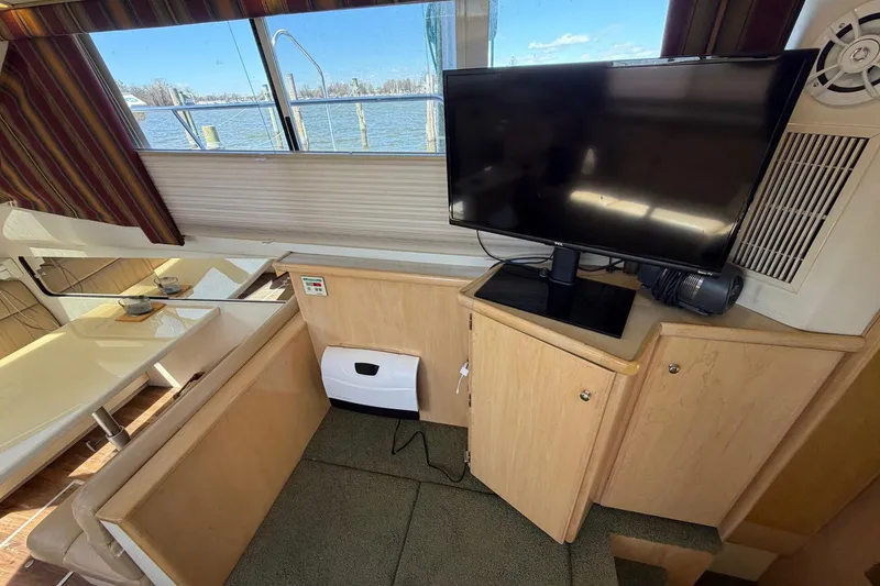 Slide: The Image of Interior of 1997 Carver 400 Cockpit Motor Yacht with TV and dining area. - 29