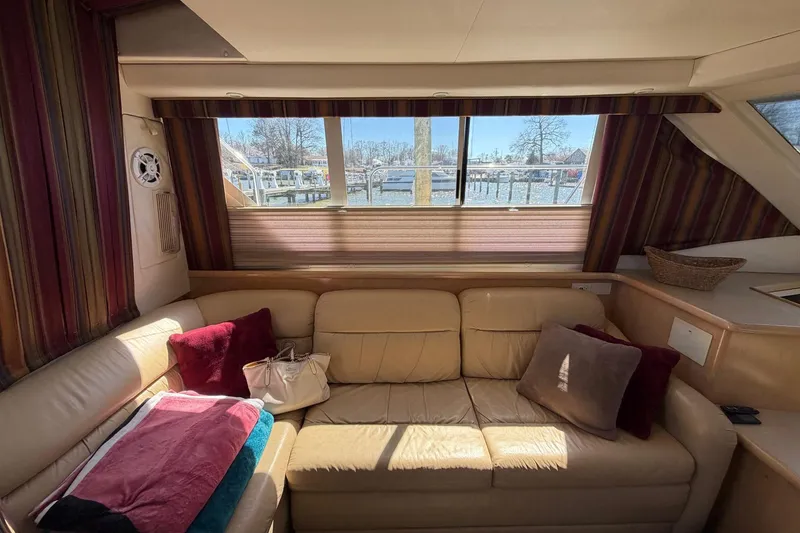 Slide: The Image of Interior of 1997 Carver 400 Cockpit Motor Yacht with beige leather seating and striped curtains. - 33