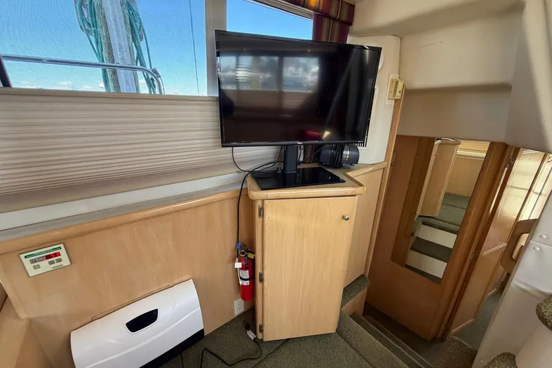 Slide: The Image of Interior of 1997 Carver 400 Cockpit Motor Yacht with TV and stairs. - 35