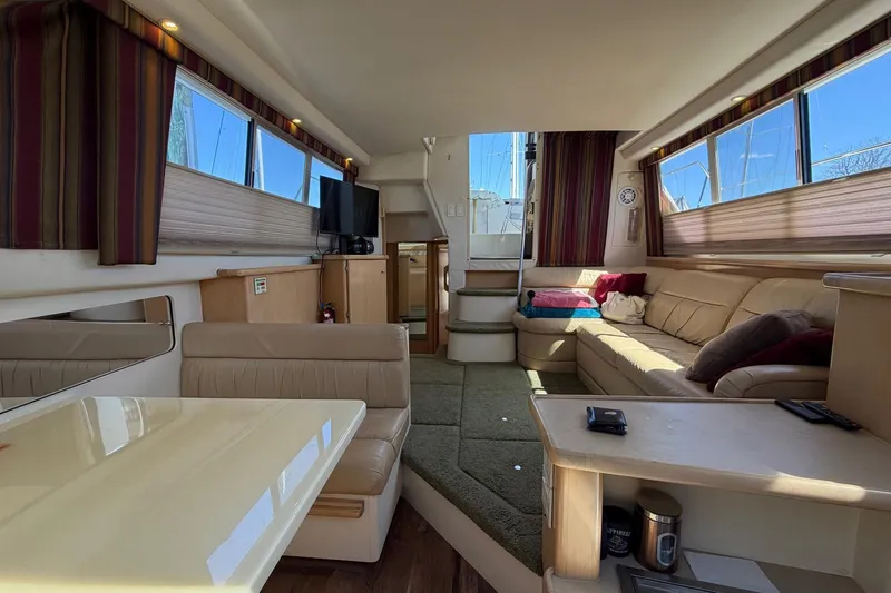 Slide: The Image of Interior of 1997 Carver 400 Cockpit Motor Yacht with cozy seating and modern amenities. - 36