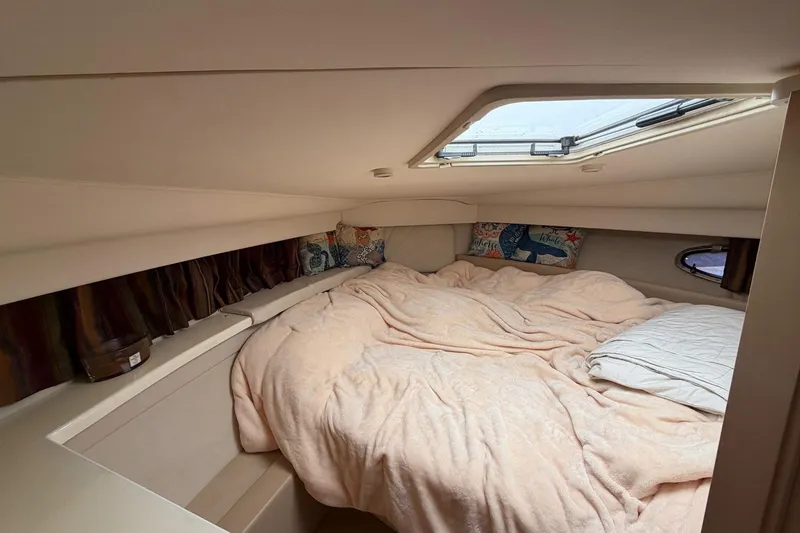 Slide: The Image of Cozy bedroom in 1997 Carver 400 Cockpit Motor Yacht with skylight and plush bedding. - 37