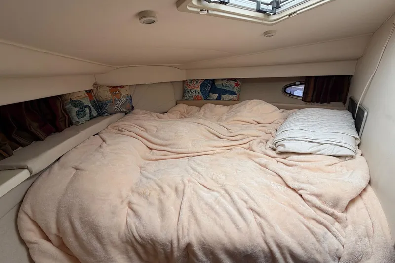Slide: The Image of Cozy cabin bedroom in 1997 Carver 400 Cockpit Motor Yacht with plush bedding. - 38