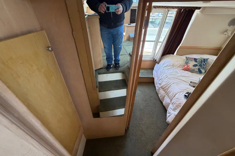 Slide: The Image of Interior of 1997 Carver 400 Cockpit Motor Yacht with cozy bedroom and mirror reflection. - 40