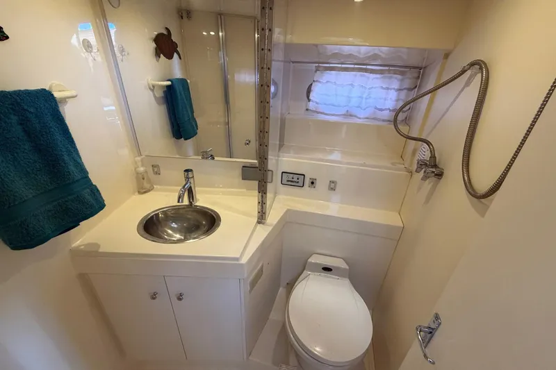Slide: The Image of Bathroom interior of 1997 Carver 400 Cockpit Motor Yacht with sink, toilet, and shower. - 41