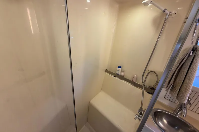 Slide: The Image of Shower area in 1997 Carver 400 Cockpit Motor Yacht with handheld showerhead and toiletries. - 47
