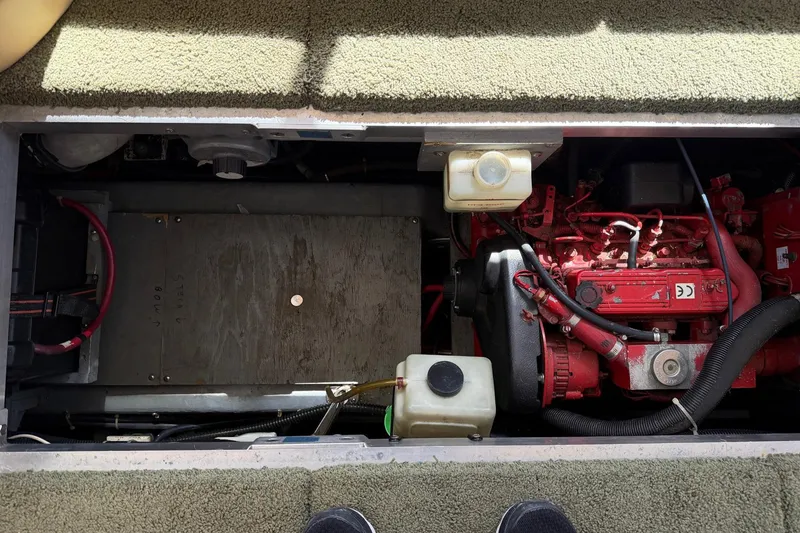 Slide: The Image of Engine compartment of a 1997 Carver 400 Cockpit Motor Yacht, featuring red engine components. - 48