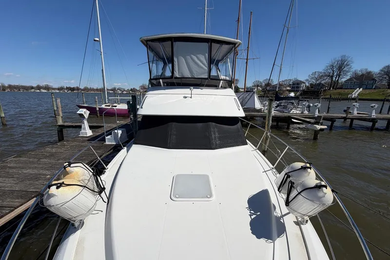 Slide: The Image of 1997 Carver 400 Cockpit Motor Yacht docked at a marina, sunny day. - 9