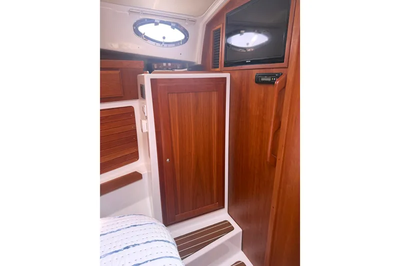Slide: The Image of 2018 Back Cove 41 yacht interior with wooden cabinetry and a mounted TV. - 15