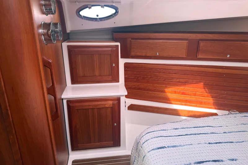 Slide: The Image of 2018 Back Cove 41 yacht interior with wooden cabinetry and porthole window. - 16