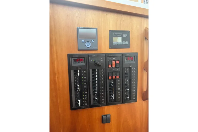 Slide: The Image of Electrical control panel on a 2018 Back Cove 41 boat, featuring various switches and displays. - 23