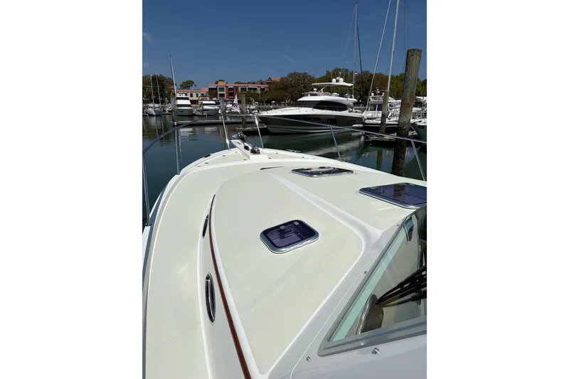 Slide: The Image of 2018 Back Cove 41 yacht docked in a marina under clear blue skies. - 25