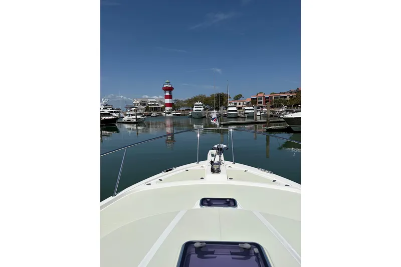 Slide: The Image of Bow view from 2018 Back Cove 41 yacht in marina with lighthouse and boats. - 26