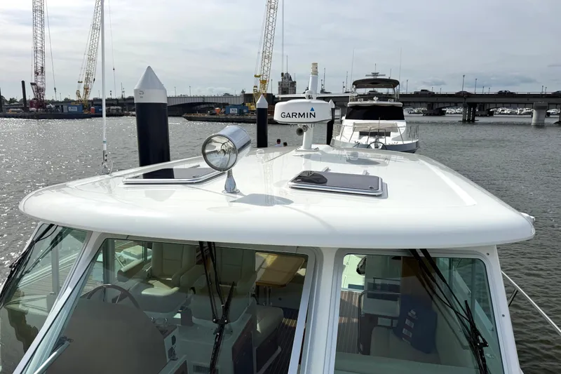 Slide: The Image of 2018 Back Cove 41 yacht with Garmin equipment docked near a bridge. - 29