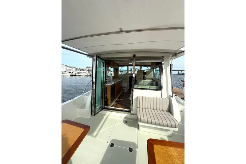 Slide: The Image of 2018 Back Cove 41 yacht interior with open sliding doors, docked at marina. - 5