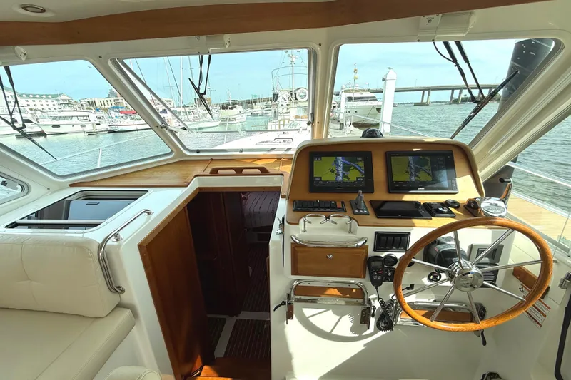 Slide: The Image of Interior helm of 2018 Back Cove 41 yacht with navigation screens and steering wheel. - 9
