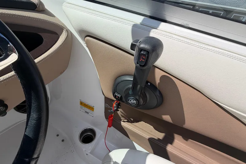 Slide: The Image of Interior of a 2014 Cobalt 210 boat showing throttle control and steering wheel. - 10