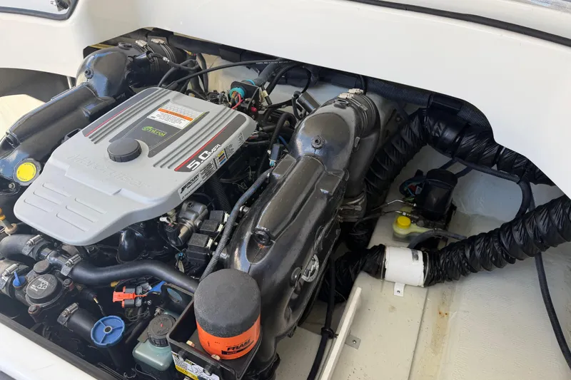Slide: The Image of Engine compartment of a 2014 Cobalt 210 boat, featuring a 5.0 MPI MerCruiser engine. - 14
