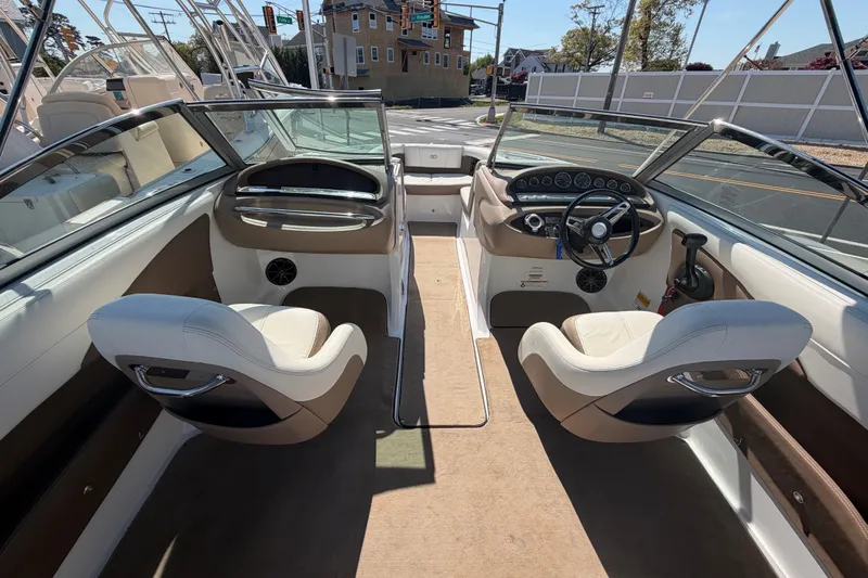 Slide: The Image of Interior of a 2014 Cobalt 210 boat with dual seating and dashboard controls. - 17