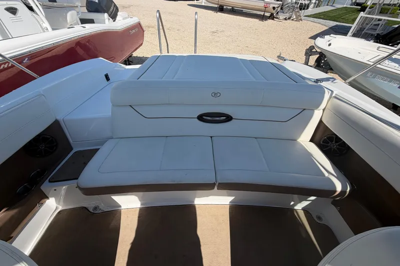 Slide: The Image of 2014 Cobalt 210 boat interior with white seating and sleek design. - 19