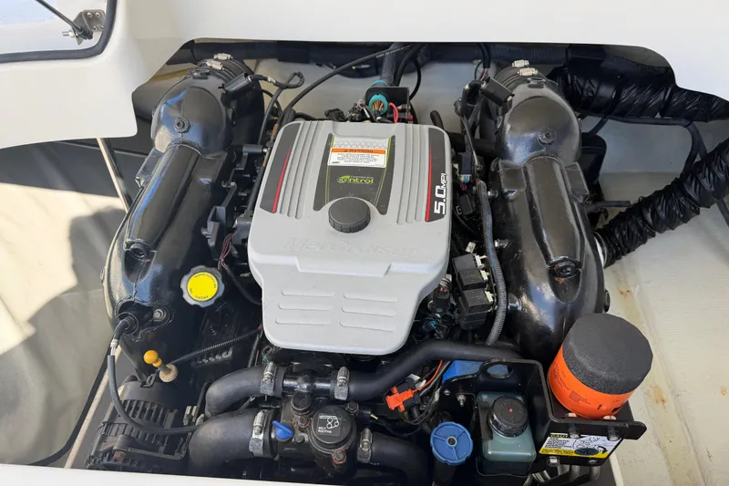 Slide: The Image of Engine compartment of a 2014 Cobalt 210 boat, featuring a 5.0 MPI engine. - 20