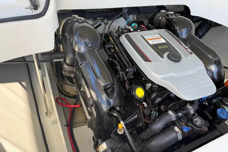 Slide: The Image of Engine compartment of a 2014 Cobalt 210 boat, featuring a MerCruiser engine. - 21