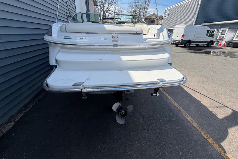 Slide: The Image of Rear view of a 2014 Cobalt 210 boat parked near a building. - 23