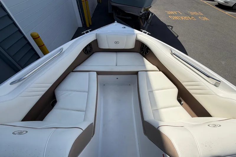 Slide: The Image of Interior of a 2014 Cobalt 210 boat with white cushioned seating. - 4