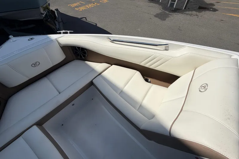 Slide: The Image of 2014 Cobalt 210 boat interior with white leather seating and speaker detail. - 5