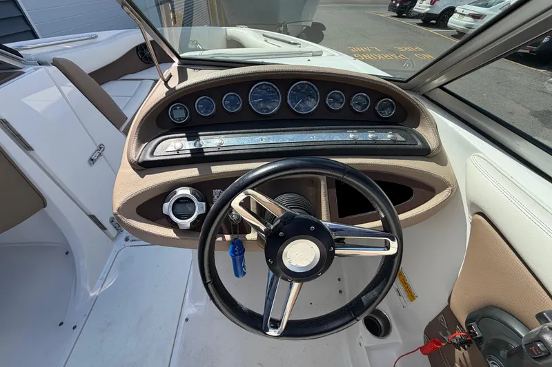 Slide: The Image of Steering console of a 2014 Cobalt 210 boat with gauges and controls. - 9