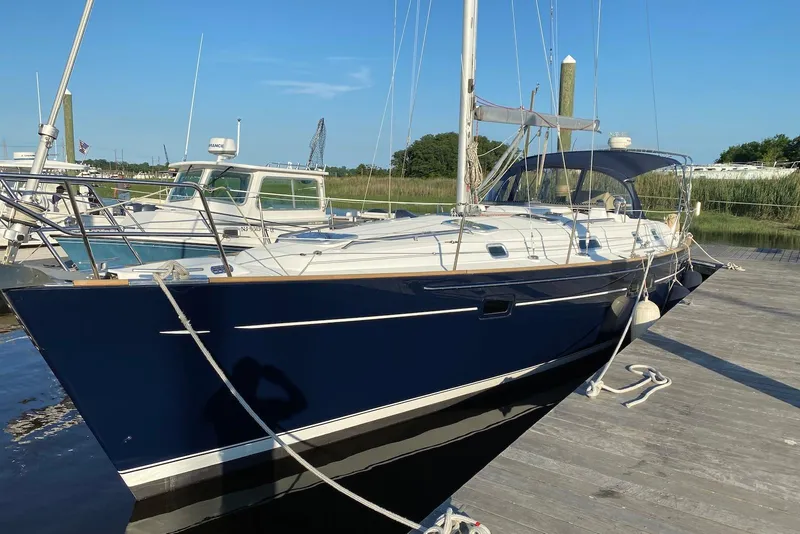 The Image of 2002 Beneteau Oceanis Clipper 411 sailboat docked, featuring sleek design and blue hull. - 0