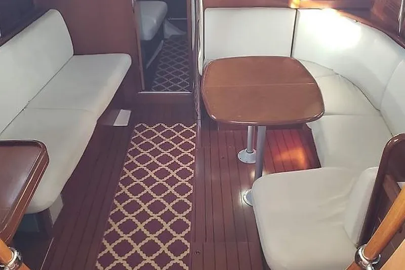 Slide: The Image of Interior of 2002 Beneteau Oceanis Clipper 411 yacht with elegant seating and wooden table. - 4