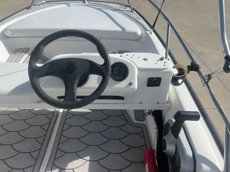 Slide: The Image of Steering console of a 2002 Boston Whaler 130 Sport boat. - 22